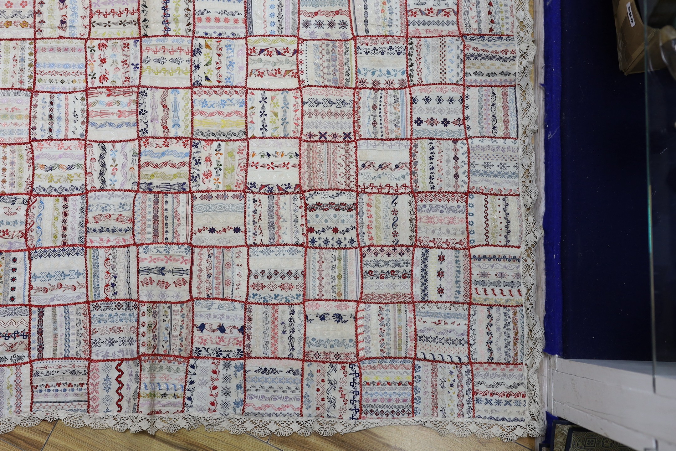 A French early 20th century ribbon patchwork cover with lace trimmimg